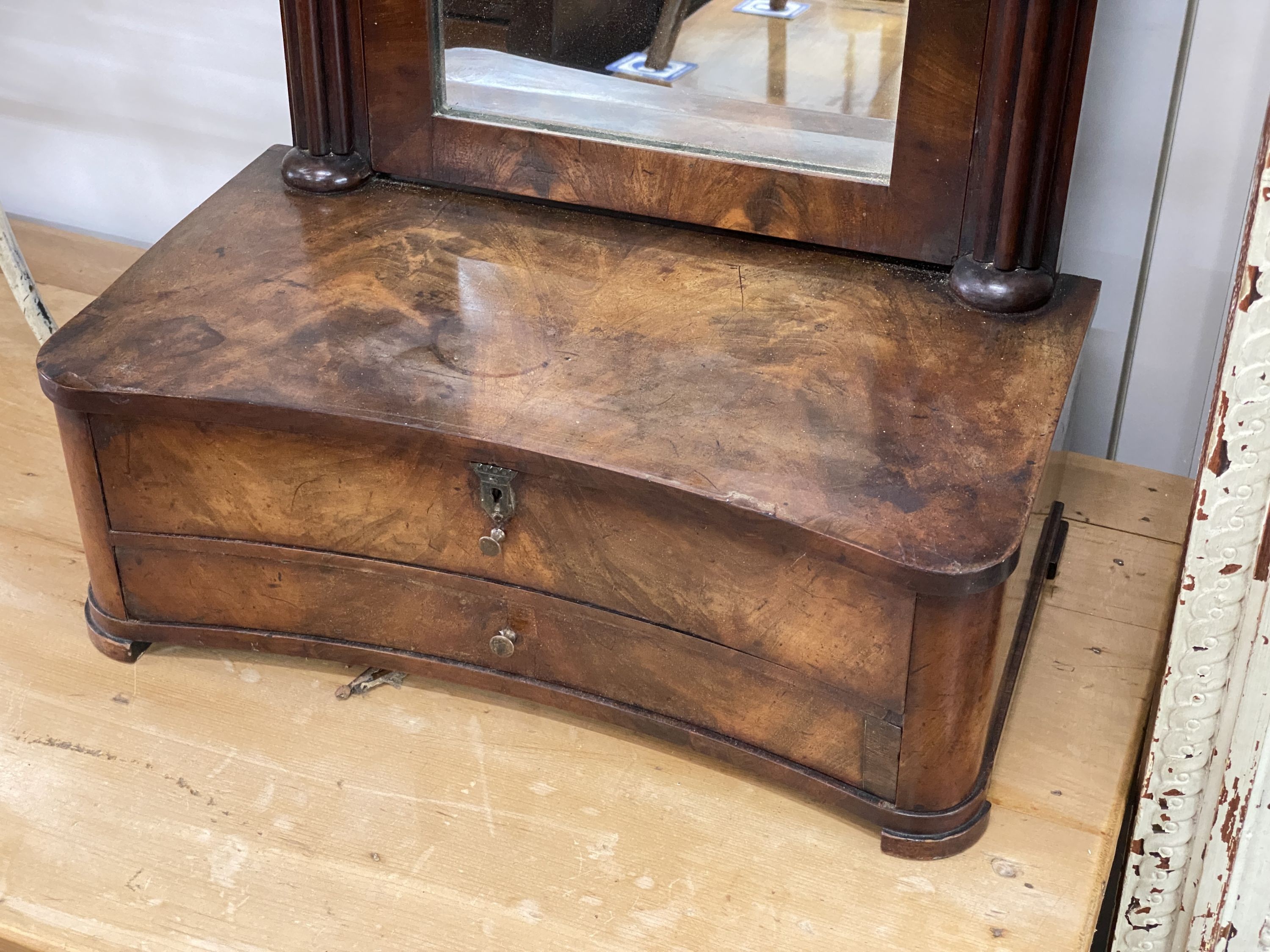 A 19th century Continental mahogany toilet mirror, with concave two drawer base, width 48cm, depth 26cm, height 72cm